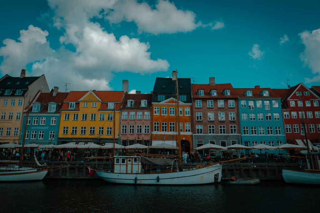 Vibrant boats and historic buildings line the iconic Nyhavn canal in Copenhagen, Denmark.